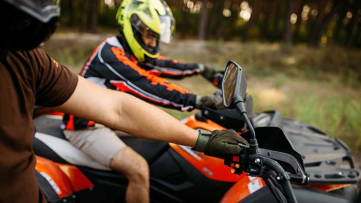 Friends ride ATVs on a Forest Trail
